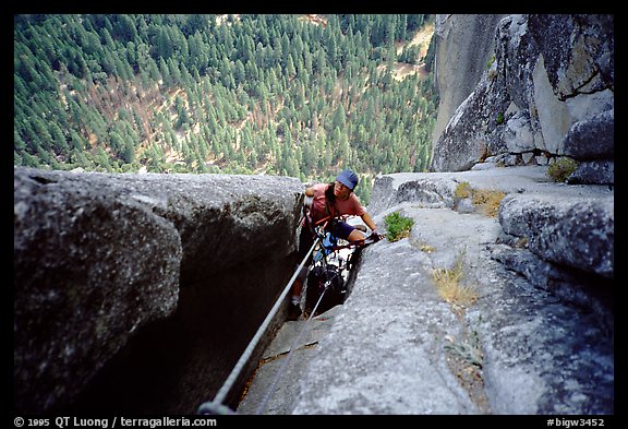 We suffer hauling through a chimney. Washington Column, Yosemite, California (color)