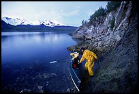 Kayaker pulling on shore at midnight, Muir Inlet. Glacier Bay National Park, Alaska (color)