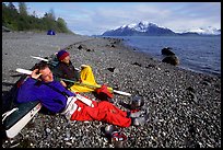 Kayakers relaxing on a beach between Rendu Inlet and Russel Island. Glacier Bay National Park, Alaska