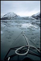 Kayaks prow, floating icebergs, and glacier. Glacier Bay National Park, Alaska