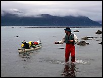 Kayaker tows kayak near Scidmore Bay. Glacier Bay National Park, Alaska