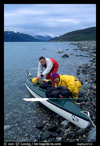 Kayaker packing tight into a double kayak. Glacier Bay National Park, Alaska (color)