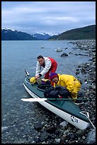 Kayaker packing tight into a double kayak. Glacier Bay National Park, Alaska (color)