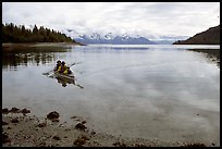 Kayakers paddle a double kayak in Hugh Miller Inlet. Glacier Bay National Park, Alaska