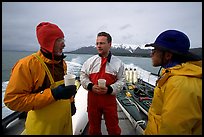 Kayakers in dry suits on the deck of Glacier Bay Lodge concession boat. Glacier Bay National Park, Alaska (color)