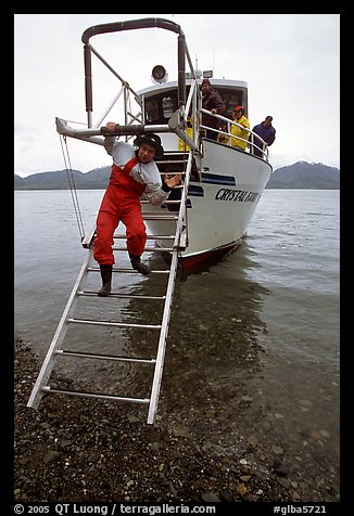 Kayaker comes down Glacier Bay Lodge concession boat for a drop-off. Glacier Bay National Park, Alaska (color)
