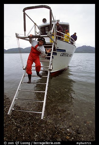 Kayaker comes down Glacier Bay Lodge concession boat for a drop-off. Glacier Bay National Park, Alaska