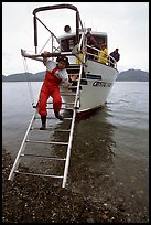 Kayaker comes down Glacier Bay Lodge concession boat for a drop-off. Glacier Bay National Park, Alaska