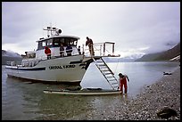 Kayaker retrieving kayak after drop-off. Glacier Bay National Park, Alaska ( color)