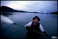 Kayaker paddling in Muir Inlet at midnight. Glacier Bay National Park, Alaska (color)