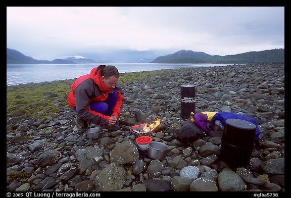 Kayaker firing up the stove,  Muir Inlet. Glacier Bay National Park, Alaska