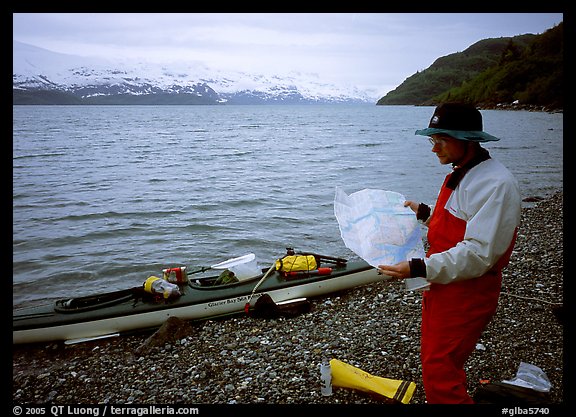 Kayaker looking at the map, East Arm. Glacier Bay National Park, Alaska