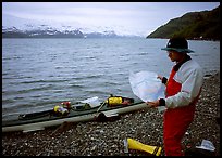 Kayaker looking at the map, East Arm. Glacier Bay National Park, Alaska