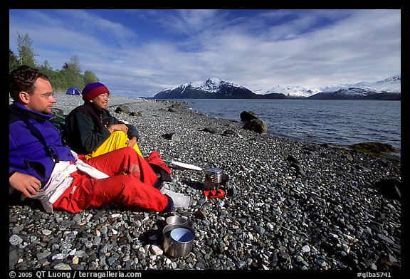 Kayakers enjoying the rare sunshine after dinner, East Arm. Glacier Bay National Park, Alaska (color)