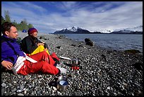 Kayakers enjoying the rare sunshine after dinner, East Arm. Glacier Bay National Park, Alaska