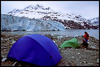 Campers set-up a tent in front of Lamplugh Glacier. Glacier Bay National Park, Alaska