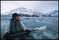 Kayaker pausing amongst icebergs near John Hopkins Inlet. Glacier Bay National Park, Alaska