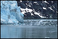 Kayaker paddling away from Lamplugh Glacier. Glacier Bay National Park, Alaska (color)