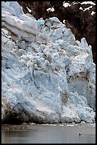 Kayaker dwarfed by Lamplugh Glacier. Glacier Bay National Park, Alaska ( color)