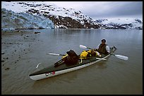 Kayaker sitting in loaded double kayak near Lamplugh Glacier. Glacier Bay National Park, Alaska