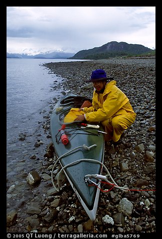 Kayaker unloading kayak. Glacier Bay National Park, Alaska