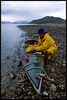 Kayaker unloading kayak. Glacier Bay National Park, Alaska