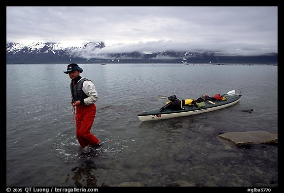 Kayaker towing kayak, East arm. Glacier Bay National Park, Alaska (color)