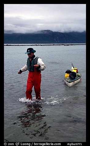 Kayaker towing kayak, East arm. Glacier Bay National Park, Alaska (color)