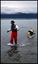 Kayaker towing kayak, East arm. Glacier Bay National Park, Alaska