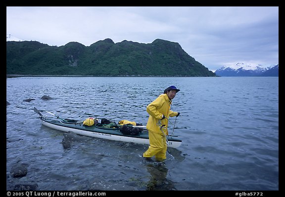 Kayaker towing kayak, East arm. Glacier Bay National Park, Alaska (color)