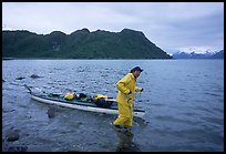 Kayaker towing kayak, East arm. Glacier Bay National Park, Alaska