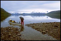 Kayaker standing in Scidmore Bay next to a shallow tidal channel. Glacier Bay National Park, Alaska (color)