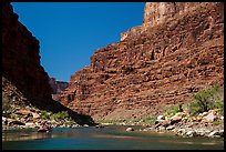 Rafts on Colorado River below towering cliffs. Grand Canyon National Park, Arizona