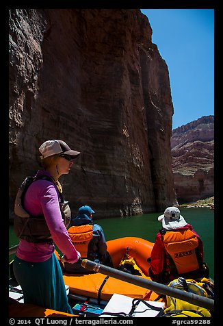 On raft below redwall limestone cliff dropping straight into Colorado River. Grand Canyon National Park, Arizona