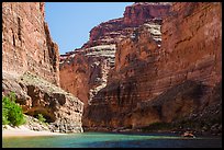 Raft dwarfed by huge Redwall limestone canyon walls. Grand Canyon National Park, Arizona