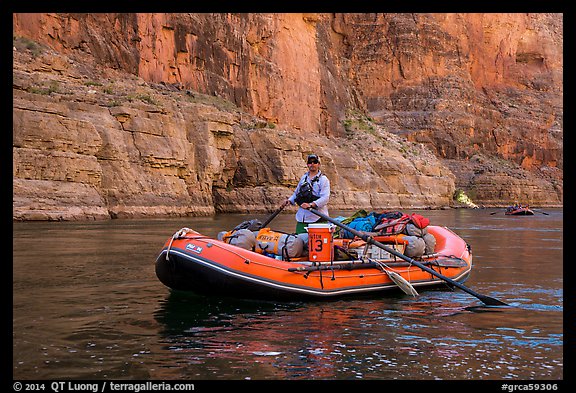 Paddling calm stretch of Colorado River between towering walls. Grand Canyon National Park, Arizona