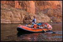 Paddling calm stretch of Colorado River between towering walls. Grand Canyon National Park, Arizona