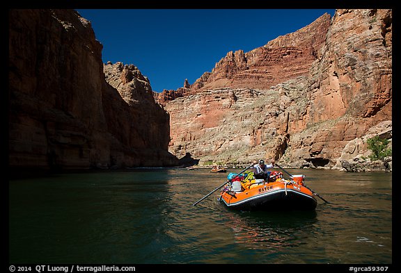 Paddling calm stretch of Colorado River beneath towering walls. Grand Canyon National Park, Arizona