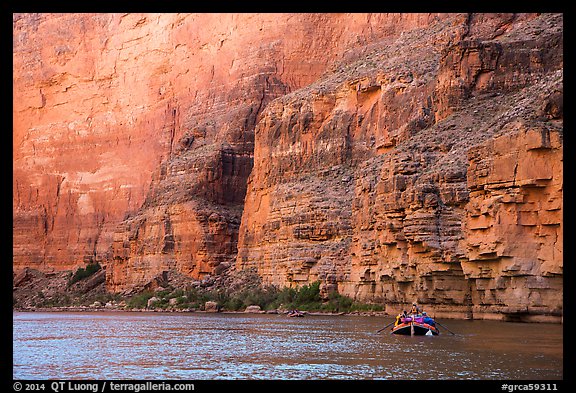 Oar raft below sheet Redwall limestone canyon walls. Grand Canyon National Park, Arizona