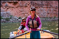 River guide rowing oar raft in narrow canyon. Grand Canyon National Park, Arizona