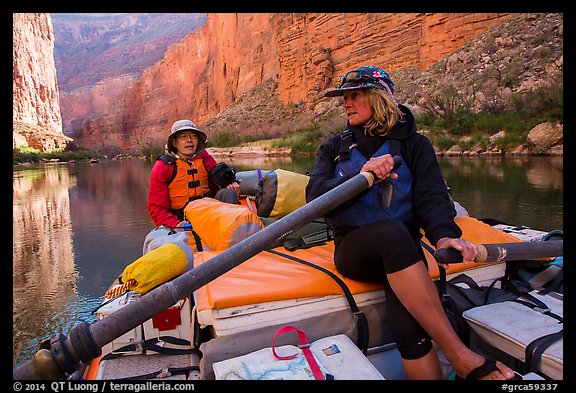 River guide converses with passenger on raft, Marble Canyon. Grand Canyon National Park, Arizona (color)