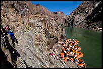 Scrambling on rocks towards rafts at the month of Clear Creek canyon. Grand Canyon National Park, Arizona