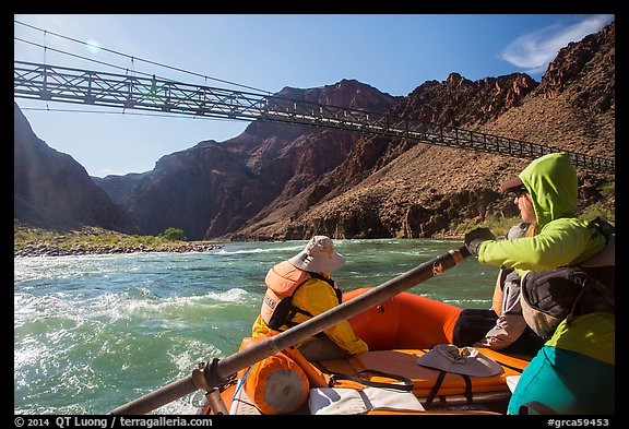 Raft passing below Bright Angel Bridge as hikers looks on. Grand Canyon National Park, Arizona (color)