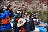 Photographers on a motorized raft wearing life jackets, taking pictures during a Grand Canyon river trip. Grand Canyon National Park, Arizona ( color)