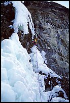 One month later, despite degrading conditions, Kevin Normoyle efficiently led the first two mixed pitches. He is at the crux move, oblique, overhanging, and thin. Lilloet, British Columbia, Canada (color)