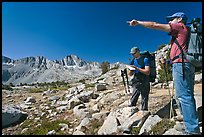 Hikers looking at map and pointing, Dusy Basin. Kings Canyon National Park, California ( color)