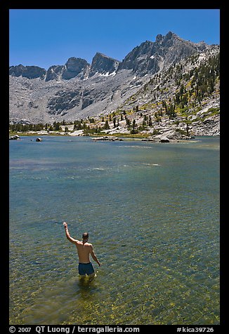 Man standing in alpine lake, lower Dusy Basin. Kings Canyon National Park, California (color)