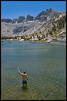 Man standing in alpine lake, lower Dusy Basin. Kings Canyon National Park, California (color)