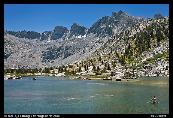 Man bathing in alpine lake, lower Dusy Basin. Kings Canyon National Park, California