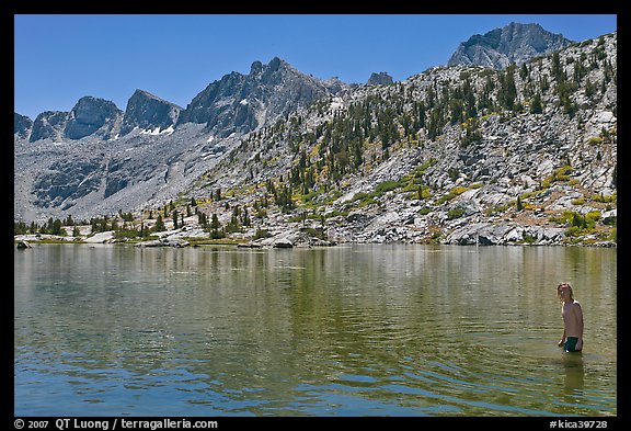 Young man in alpine lake, lower Dusy Basin. Kings Canyon National Park, California